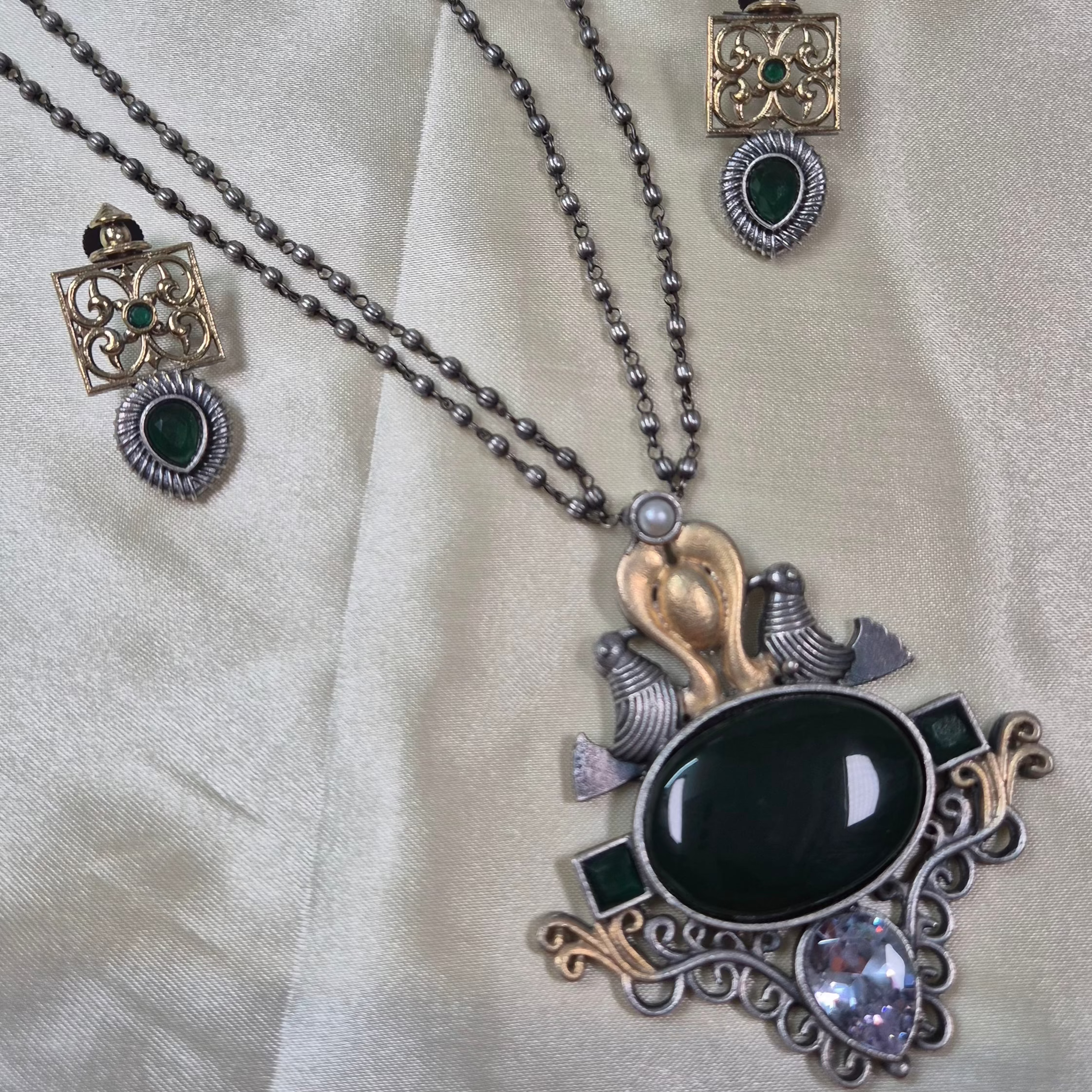 Oxidised mid length set with deep green monalisa stones