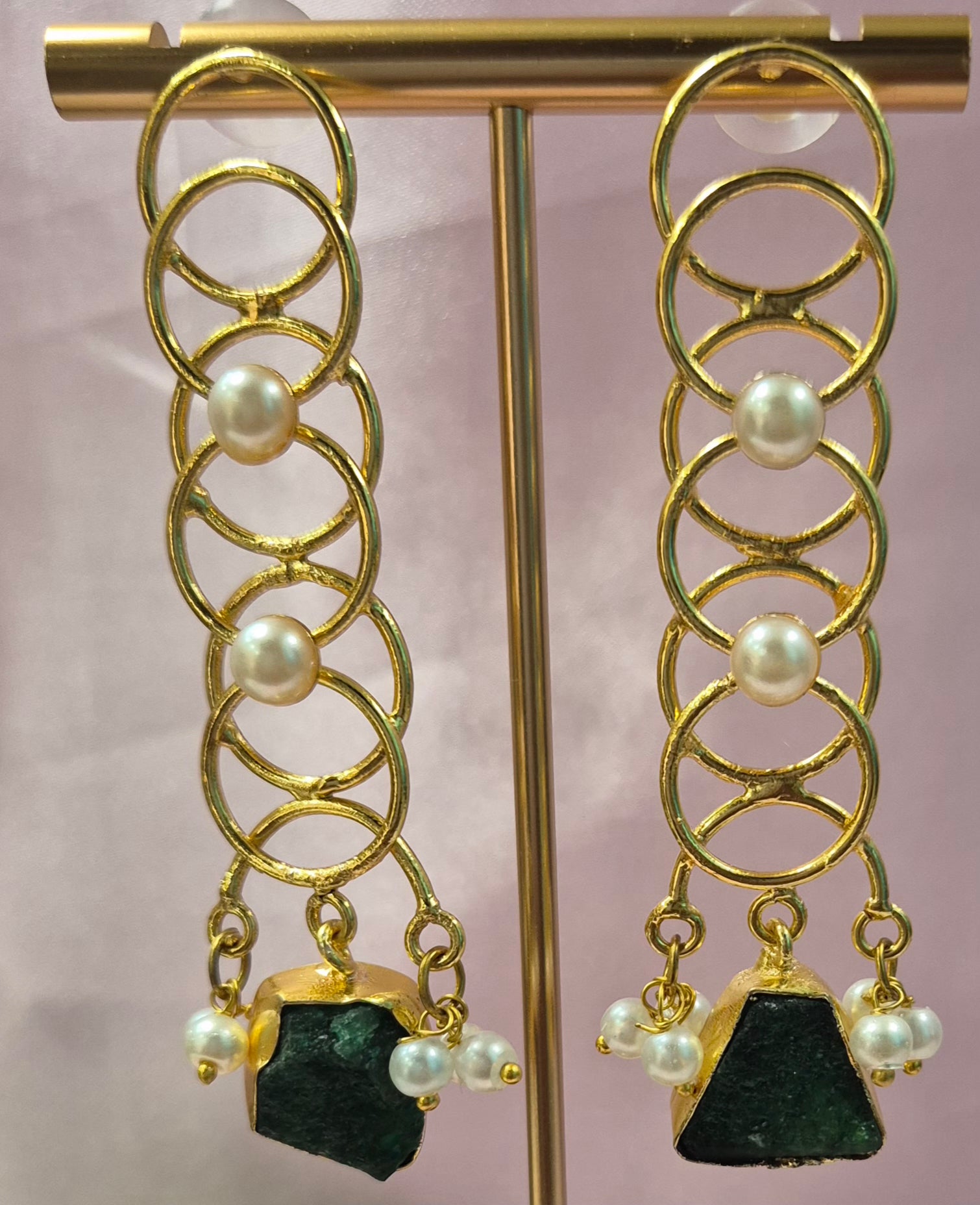 Long danglers in circular rings with green uncut stone
