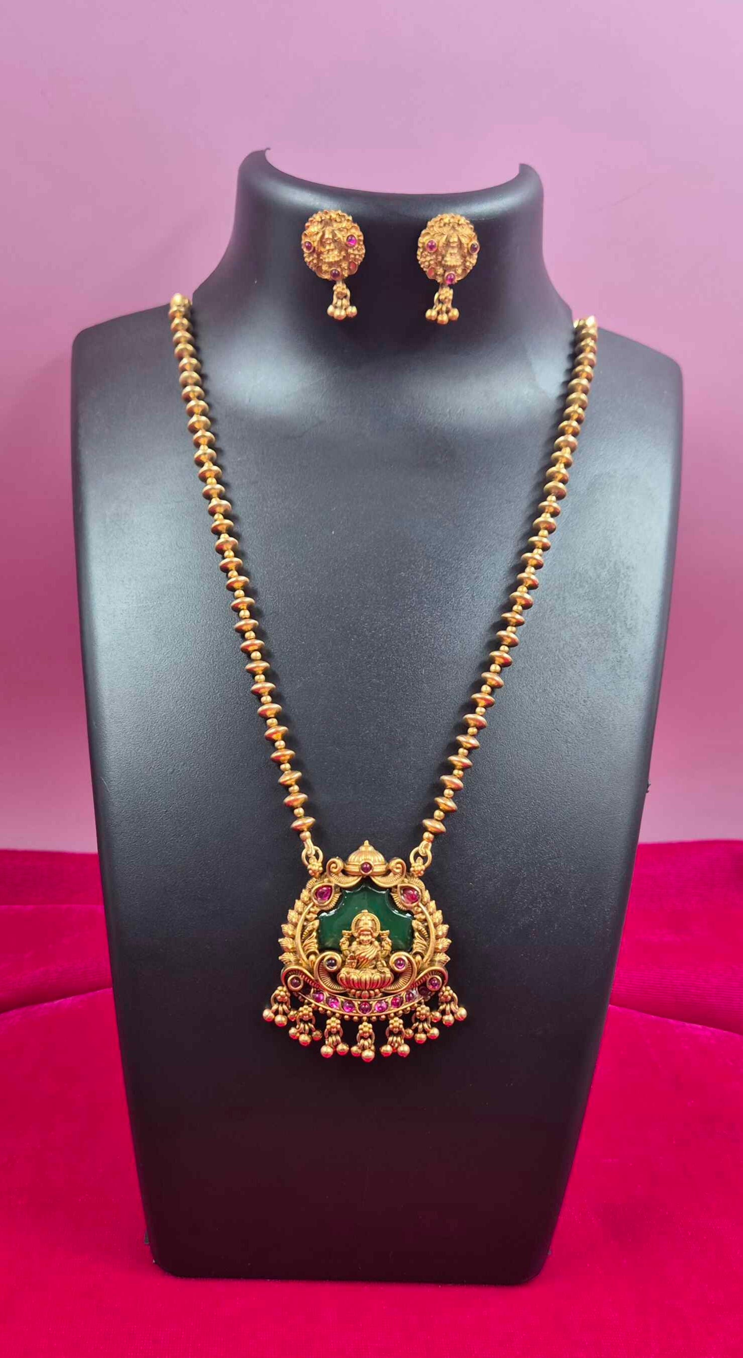 Antique Gold palaikka  Finish Lakshmi Pendant Necklace Set with Green Enamel & Ruby Stone Accents