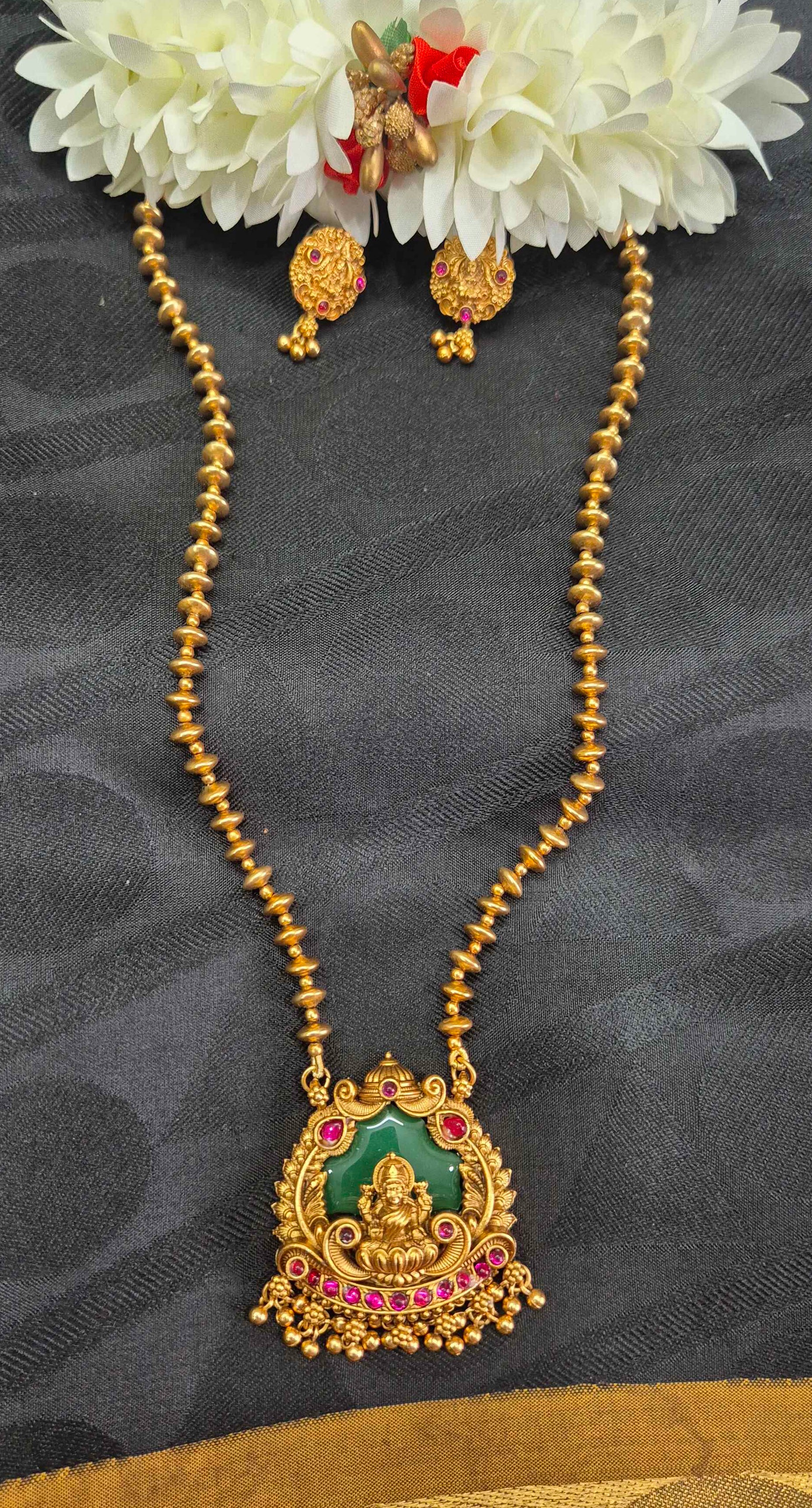 Antique Gold palaikka  Finish Lakshmi Pendant Necklace Set with Green Enamel & Ruby Stone Accents