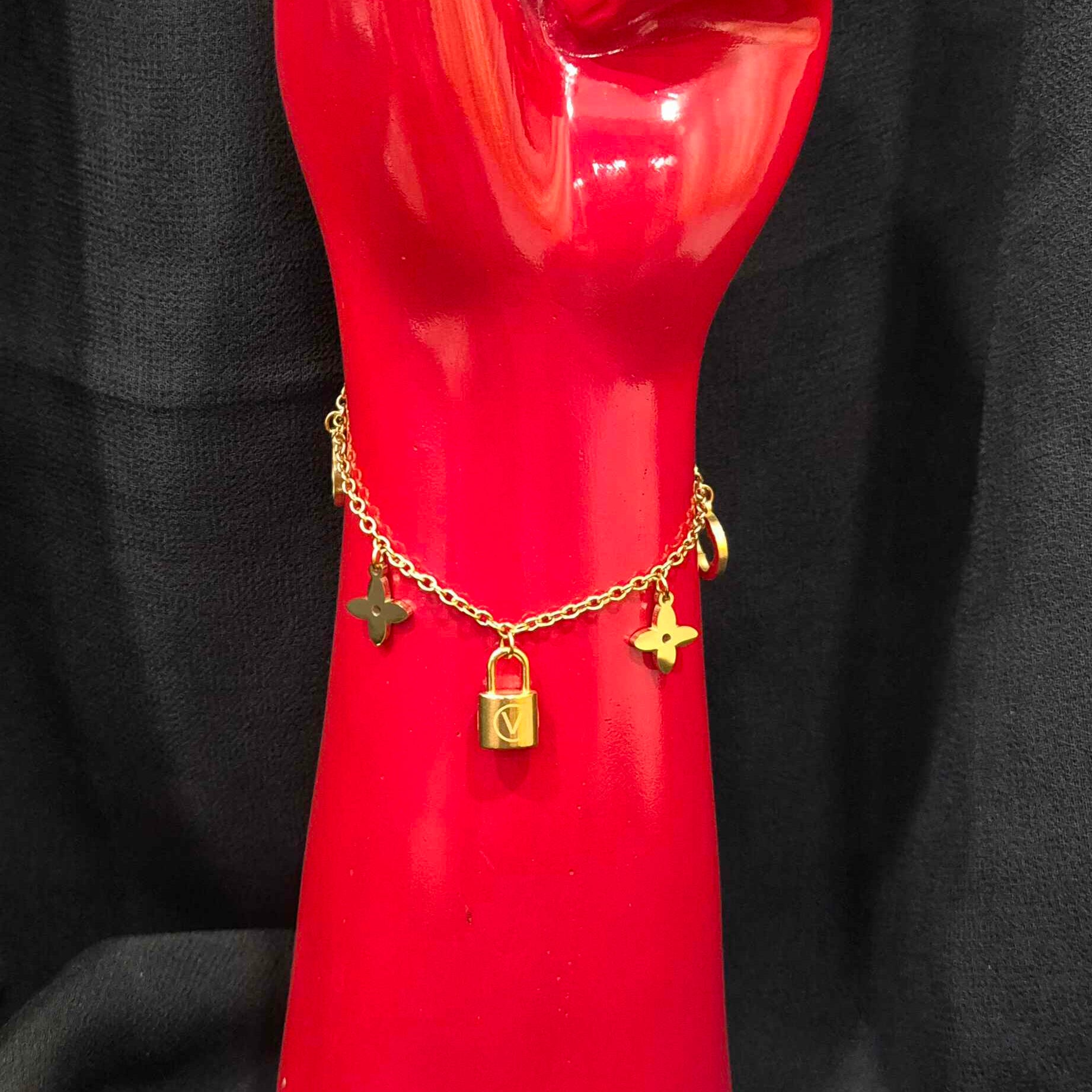 Gold-Tone Charm Bracelet with Lock and Floral Motif Charms