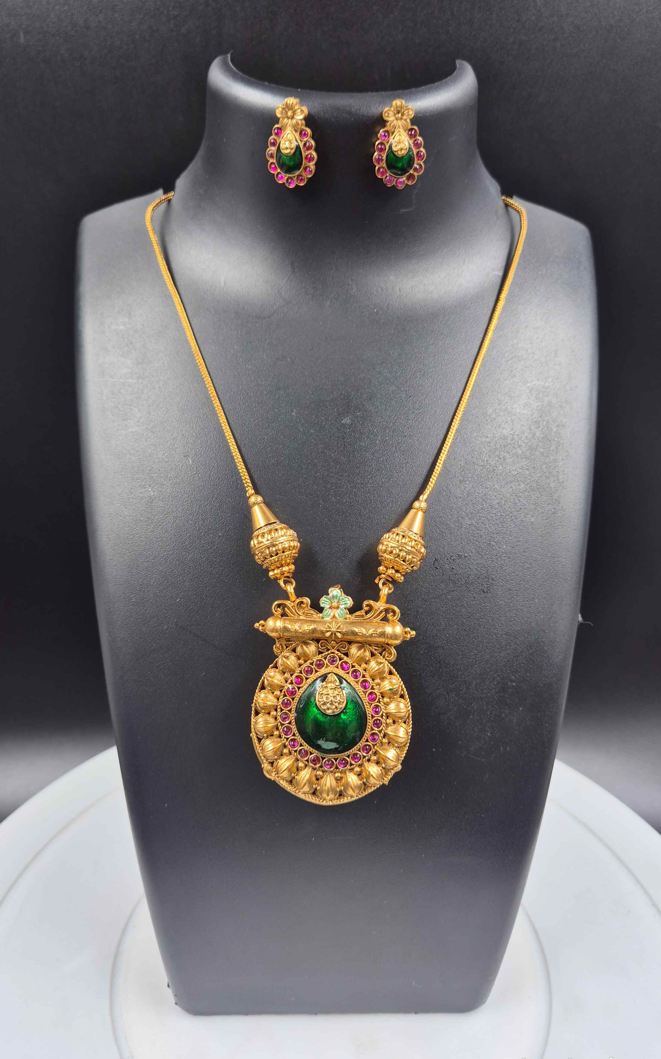Double sided round pendant-Peacock in pearl design on one side+ Green Pallaka design on another side.