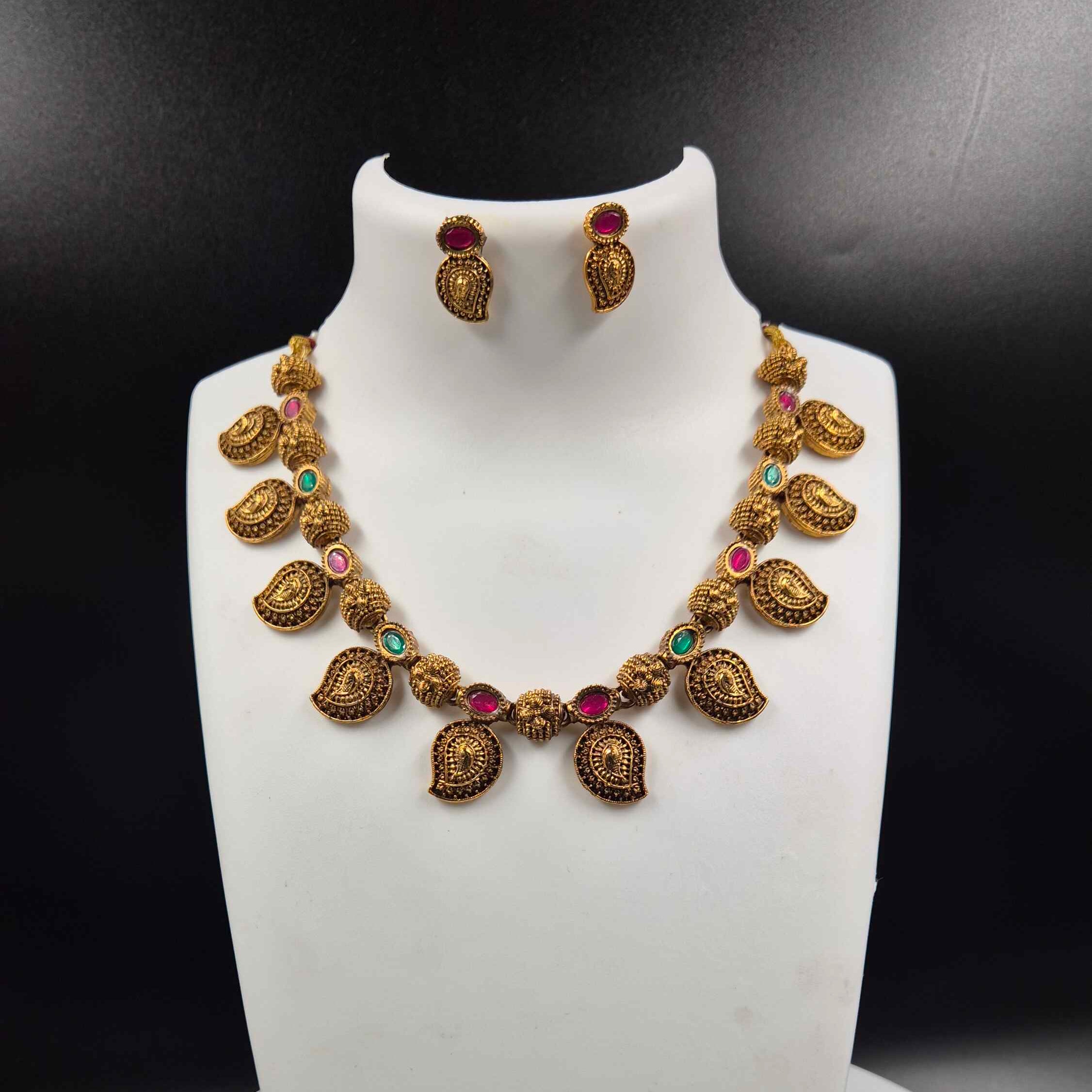 Traditional Mango necklace with green and red stones.