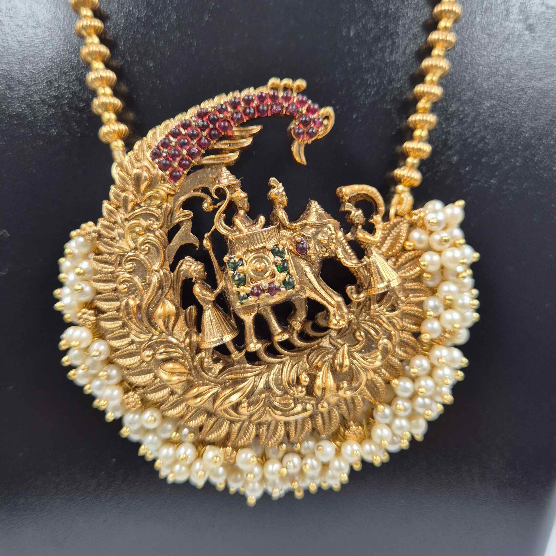King on top of elephant motif pendant haram with pearl hangings.