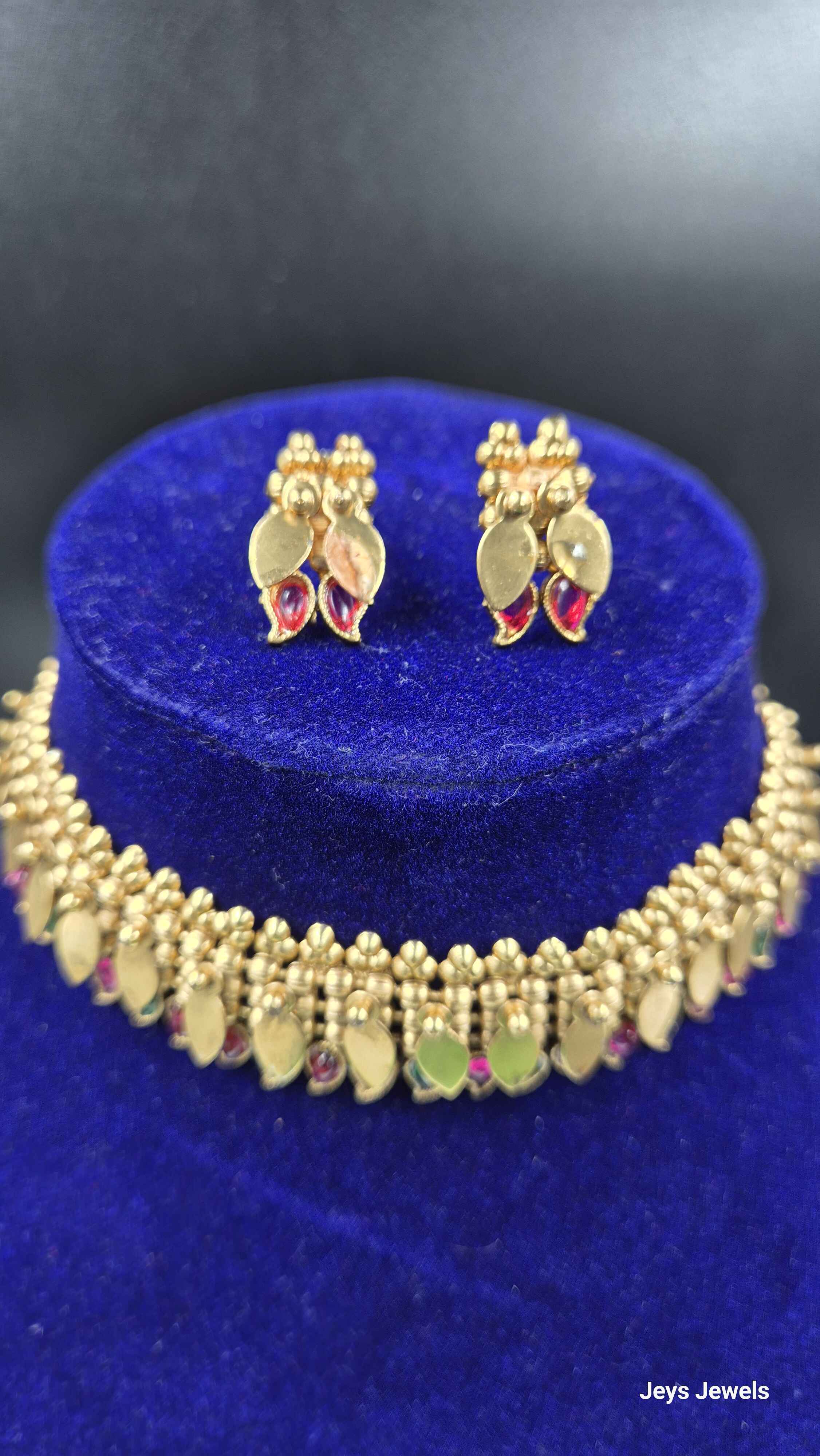 Kerala style elakkathali with green a nd red stoned mango design