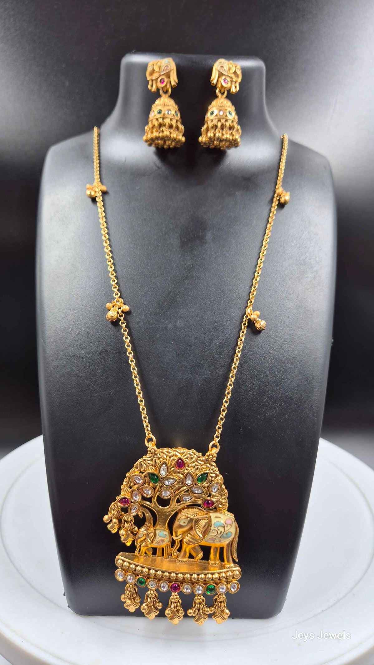 Baby and mother elephants under tree pendant in long chain