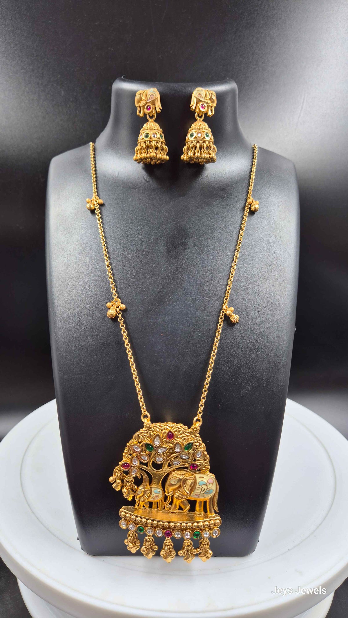 Baby and mother elephants under tree pendant in long chain