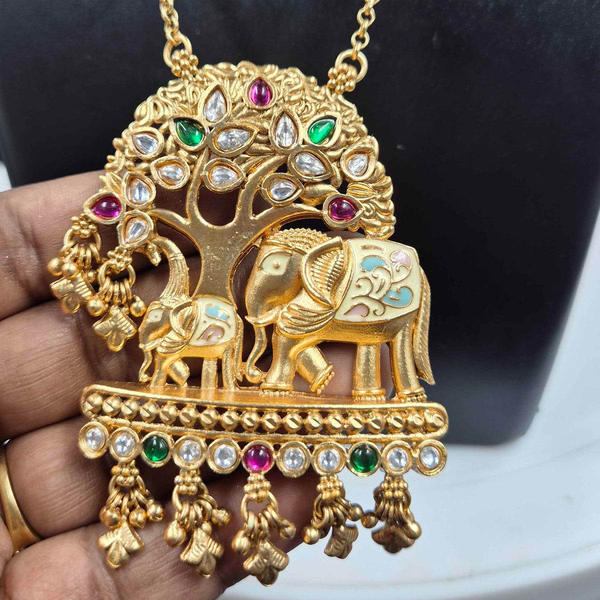 Baby and mother elephants under tree pendant in long chain